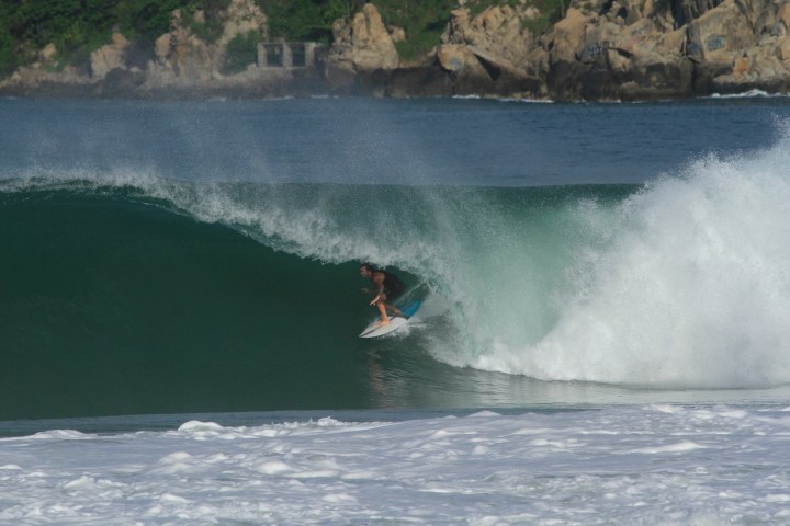 a man riding a wave on a surfboard in the water